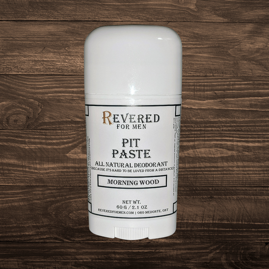 White deodorant stick with 'Revered for Men' branding on a wooden background